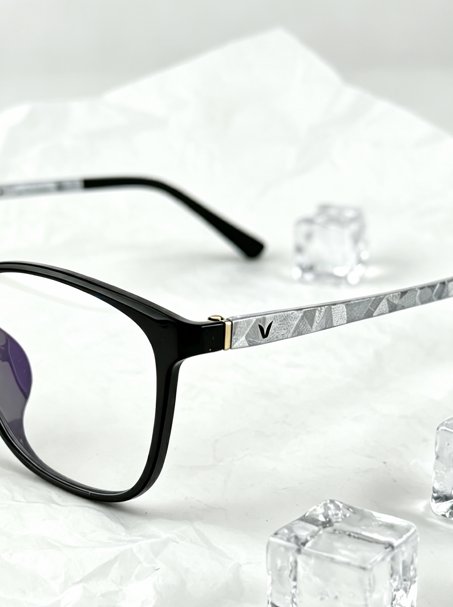 Close-up shot of black minimalist eyeglasses temple with geometric silver metal texture, minimalist acetate frame hinge detail clean aesthetic product photography